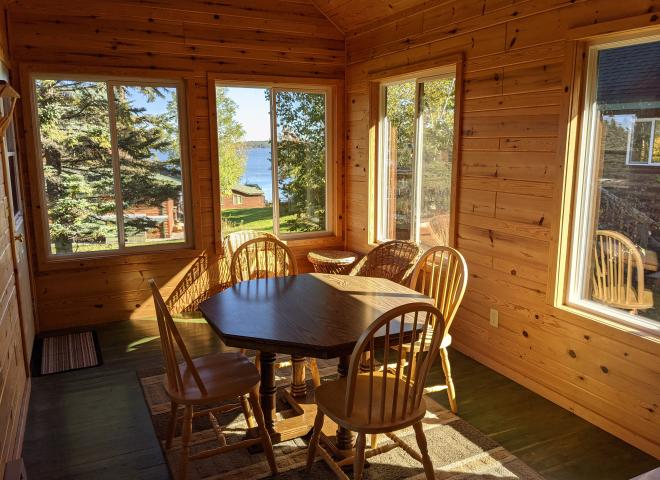 Three season porch area with seating and views of the lake.