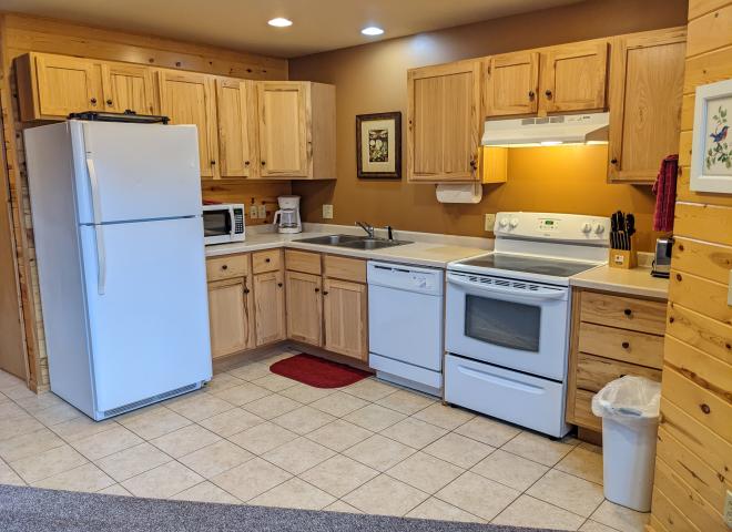 Kitchen with a refrigerator, stove, and dishwasher.