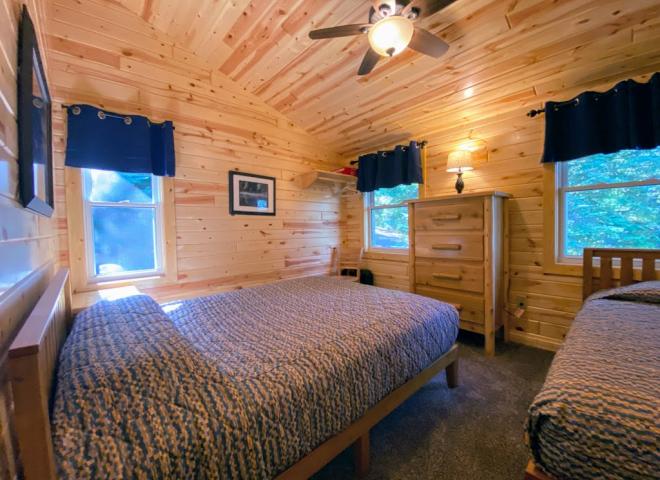 Upstairs bedroom with a queen and twin bed.