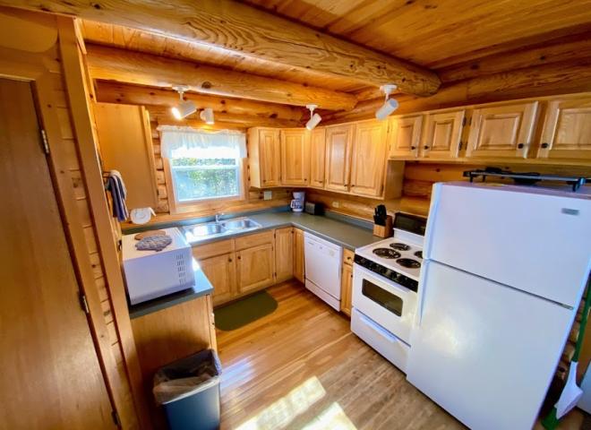 Kitchen with a refrigerator, stove, and dishwasher.