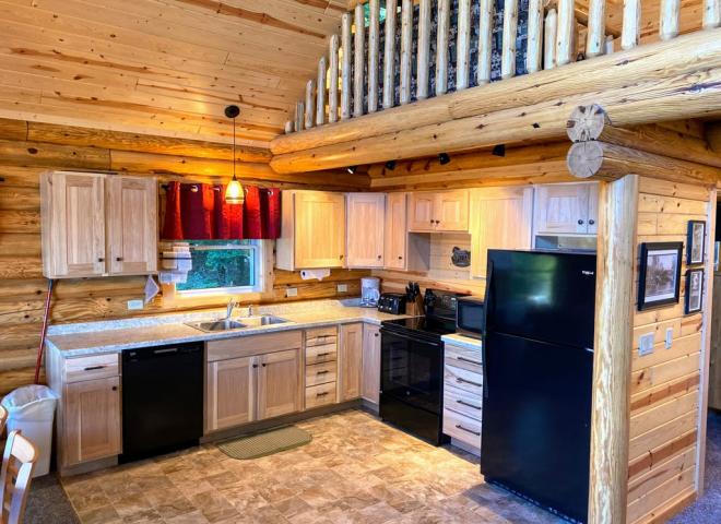 Kitchen with a refrigerator, stove, and dishwasher.