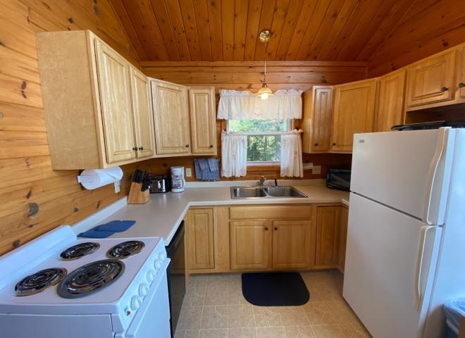 Kitchen with a refrigerator, stove, and dishwasher.