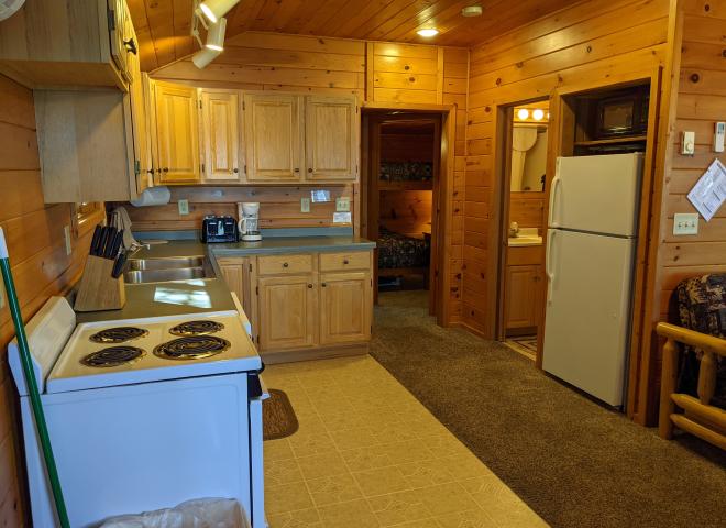 Kitchen with a refrigerator, stove, and dishwasher.