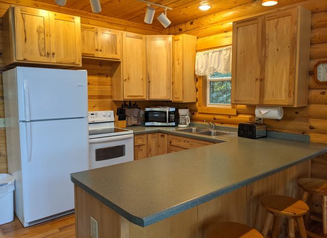 Kitchen with refrigerator, stove, and dishwasher.