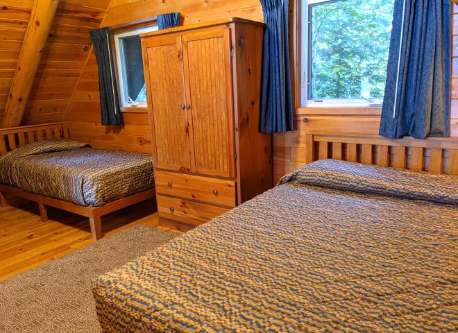 Loft bedroom with a queen and twin bed.