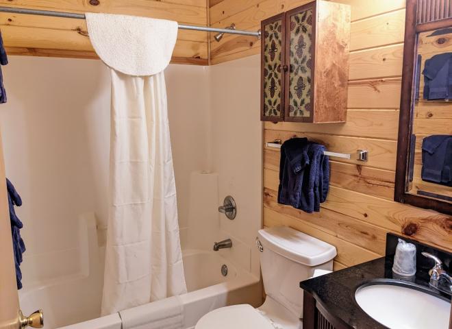 Upstairs bathroom with a standard tub/shower.