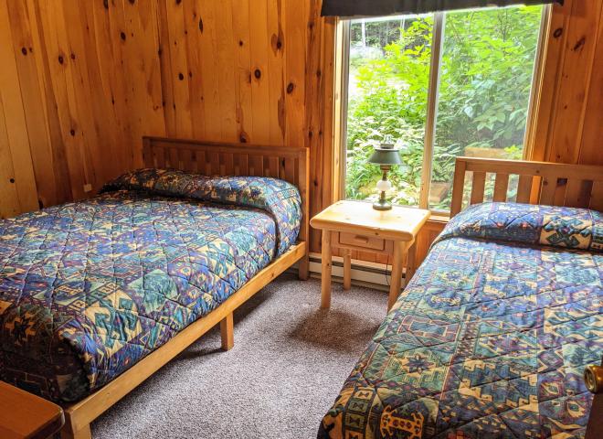 Main floor bedroom with a full size bed and twin.