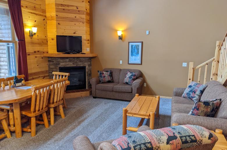 Living room with couch, loveseat, recliner, gas fireplace, and TV with streaming capabilities.