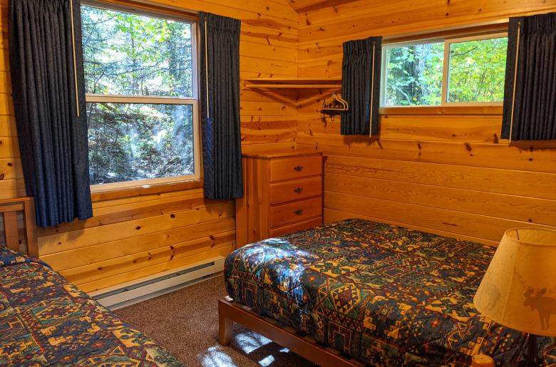 Bedroom with a full size bed, twin bed, lofted twin bed, and a ensuite bathroom.