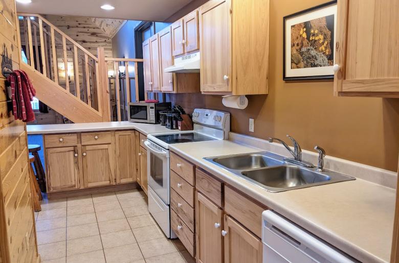 Kitchen with refrigerator, stove, and dishwasher.