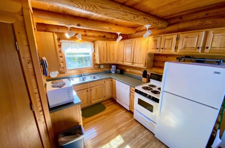 Kitchen with a refrigerator, stove, and dishwasher.