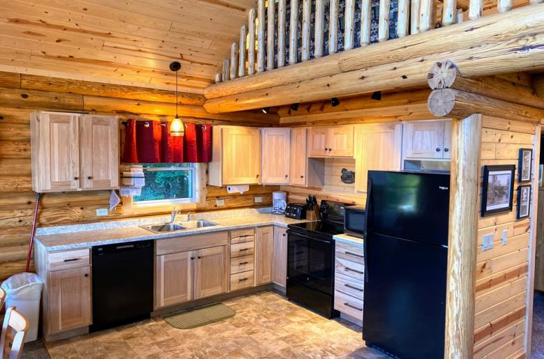 Kitchen with a refrigerator, stove, and dishwasher.