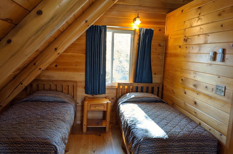 Loft bedroom with two twin beds.