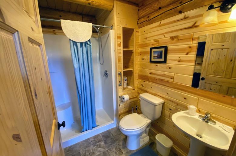 Main floor bathroom with a wide door and easy access shower and sink.
