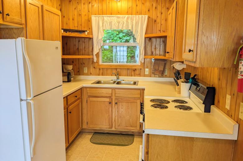 Kitchen with a refrigerator, stove, and dishwasher.