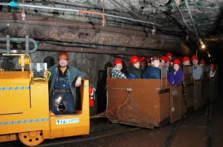Soudan Underground mine tour with tourists on the train portion.