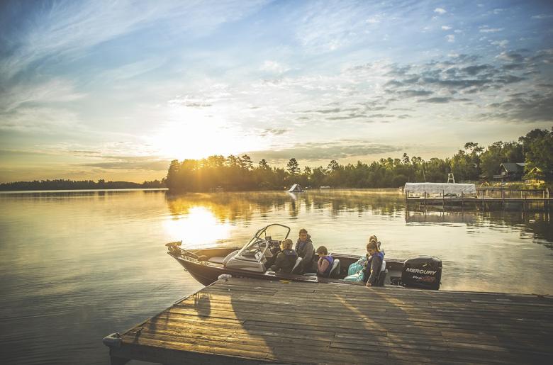 Family pushing off from the dock for a sunrise fishing adventure.