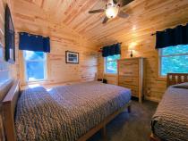 Upstairs bedroom with a queen and twin bed.