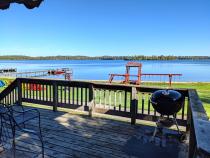 Deck area that over looks the beach and playground, also with charcoal grill.