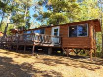 Exterior of Sunset View, nestled in the pines and views of the lake.