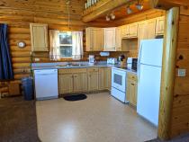 Kitchen with a refrigerator, stove, and dishwasher.
