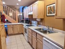 Kitchen with refrigerator, stove, and dishwasher.