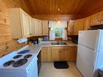 Kitchen with a refrigerator, stove, and dishwasher.