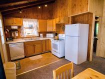 Kitchen with a refrigerator, stove, and dishwasher.