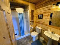 Main floor bathroom with a wide door and easy access shower and sink.