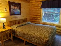 Main floor bedroom with a queen bed.