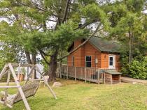 Exterior of Minnesota with firepit and swinging bench.