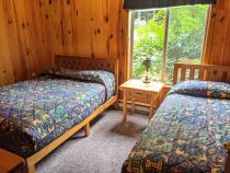 Main floor bedroom with a full size bed and twin.