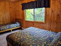 Upstairs bedroom with a queen and twin bed.