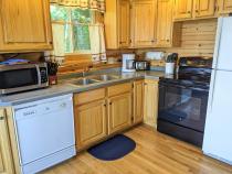 Kitchen with a refrigerator, stove, and dishwasher.
