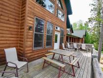 Deck area with seating, picnic table and views of the harbor.