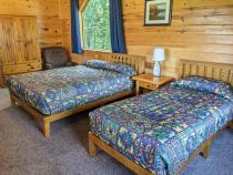 Loft bedroom with a queen and twin bed.